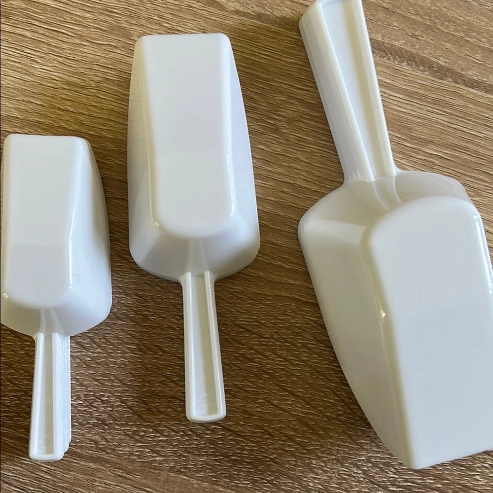 Stack of White Plastic Scoops - 11 pieces